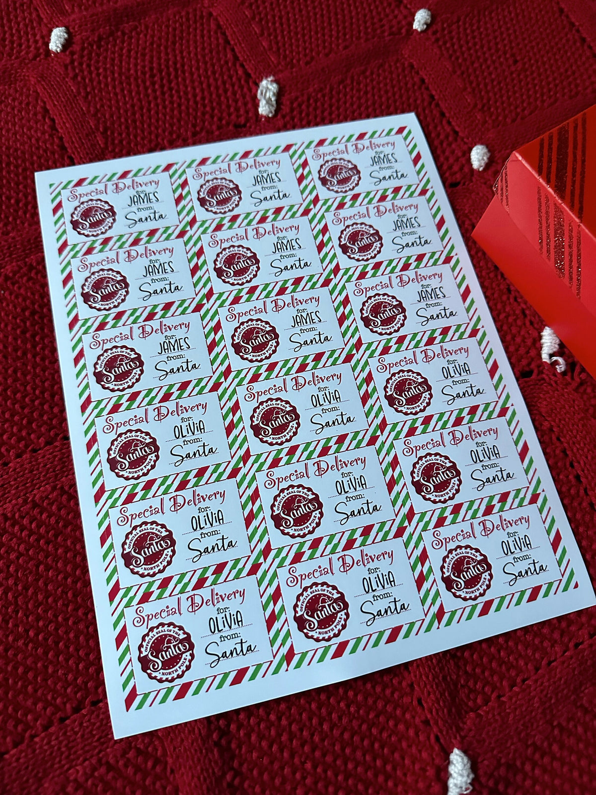 Glossy Santa gift label sheet on red knit background