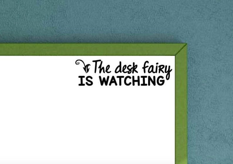 The Desk Fairy is Watching decal on whiteboard