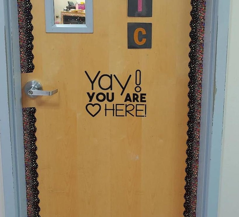 Yay You Are HERE! decal on wooden classroom door