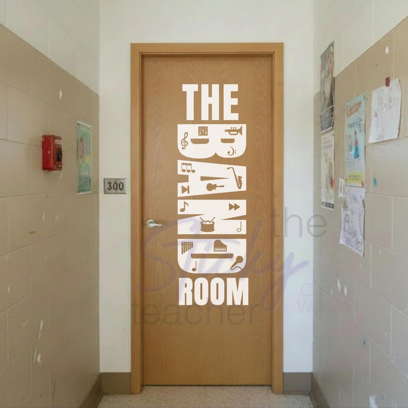 The Band Room decal on wall beside music room door with instrument cases and music stands in hallway