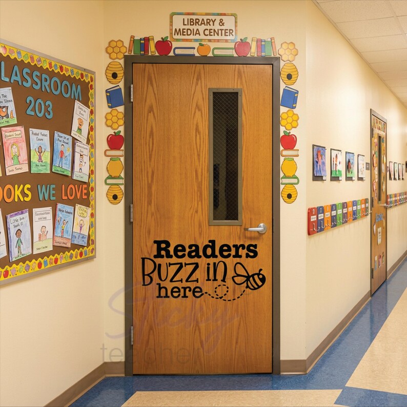 Readers Buzz in Here decal on wooden library door with apple book and honeycomb cutouts