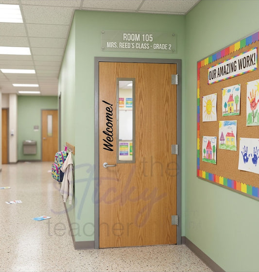 Welcome! classroom door vinyl decal on wooden door with student artwork visible