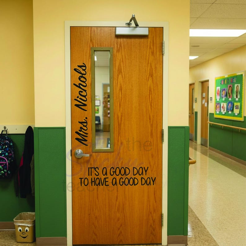 Personalized classroom door decal reading Mrs. Nichols vertically on wooden door with window